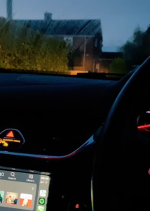 The dashboard of a car at night.